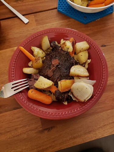 The plated beef with some roasted veggies and egg noodles.